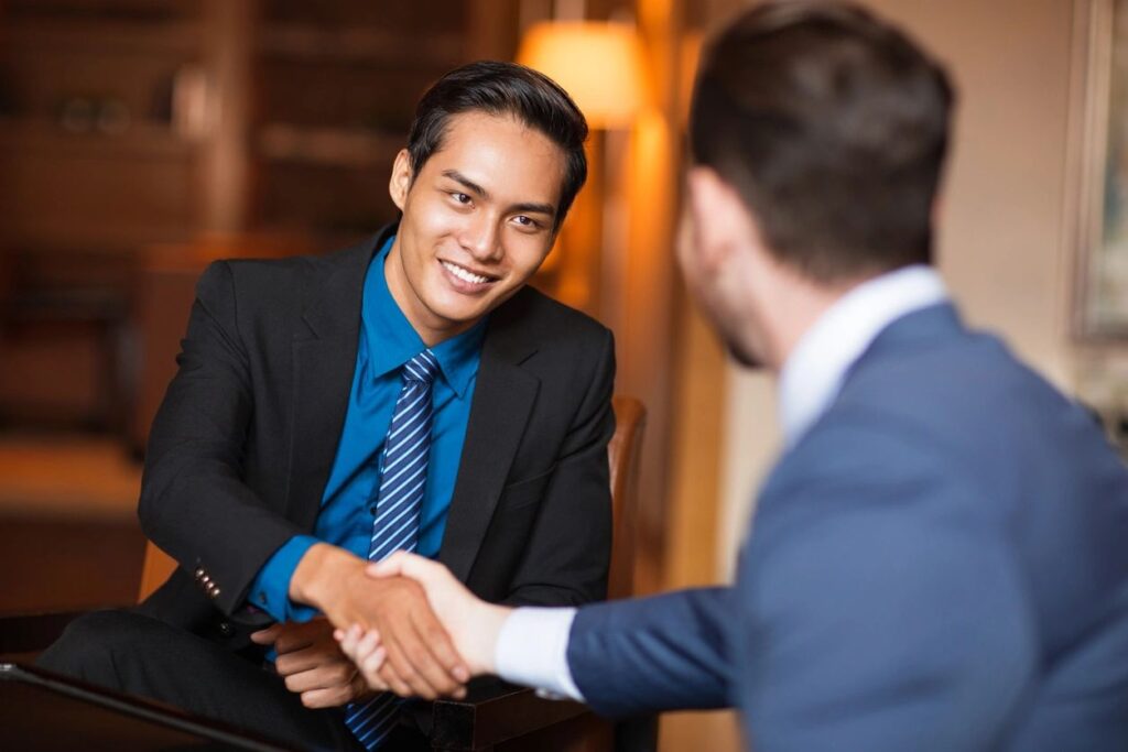 When Money Becomes Everything: This picture shows two males shaking hands. It symbolizes financial success.